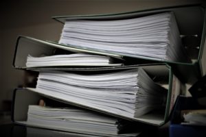 A big pile of binders full of documents